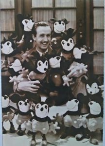 Walt Disney with a collection of Charlotte Clark Mickey Mouse dolls